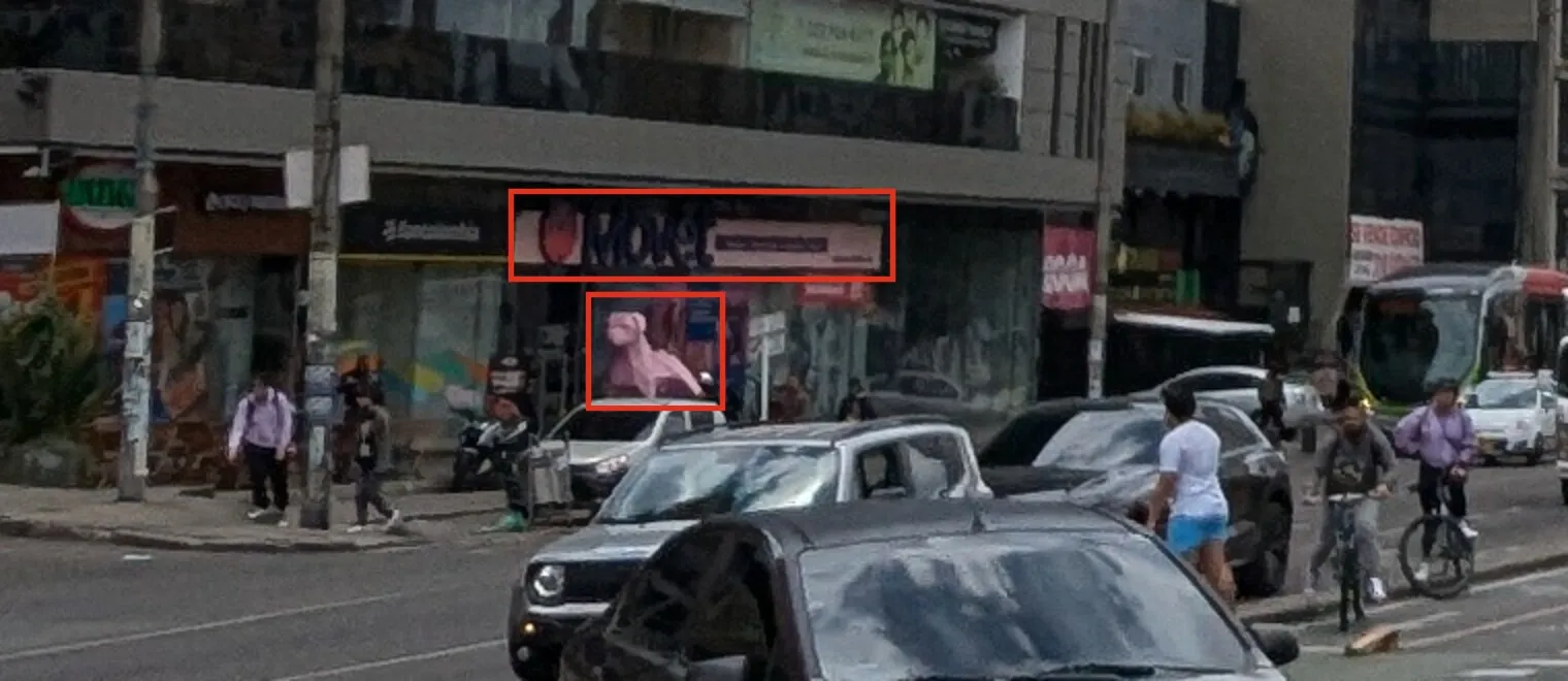 An enlarged crop of the shop front at the foot of the office block: red boxes around a sign reading Movet with a red logo, and a large pink low-poly dog statue in the shop window